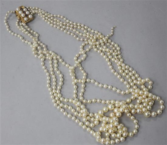 A five strand graduated cultured pearl necklace with 9ct gold, ruby and cultured pearl set clasp, 50cm.